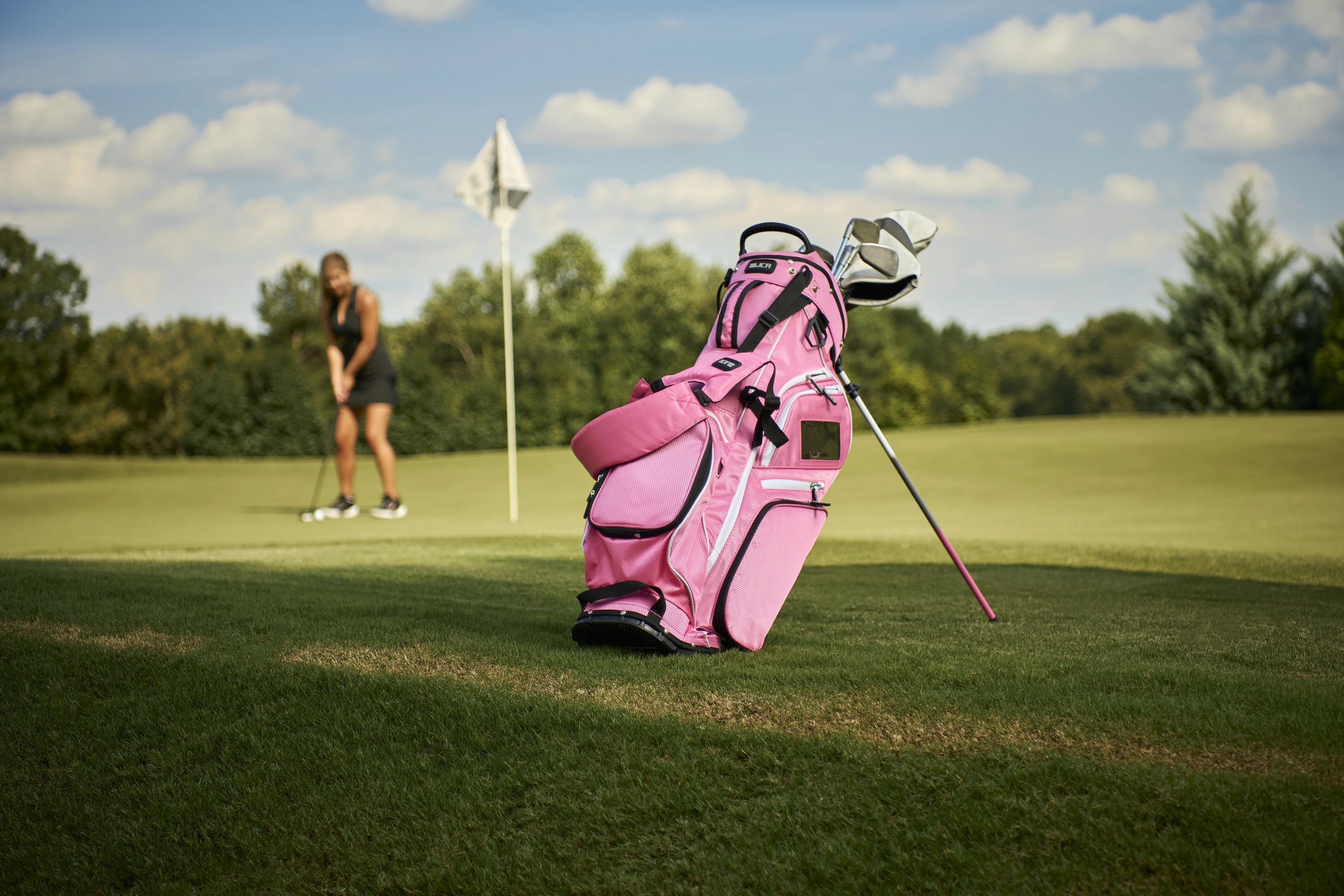 A JCR golf bag beside the green